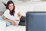 Woman enjoying tv with popcorn on sofa