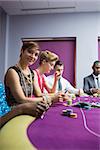 Woman smiling at the casino sitting at the poker table