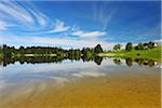 Landscape and Sky Reflecting in Lake Hegratsrieder See in Spring, Hegratsried, Halblech, Swabia, Bavaria, Germany