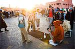 Moroccan people playing street games in Place Djemaa El Fna, the famous square in Marrakech, Morocco, North Africa, Africa