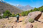 Tour guide trekking in the Imlil valley, on route from Tizi n Tamatert into Imlil, High Atlas Mountains, Morocco, North Africa, Africa