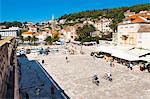 Cafes and tourists in St. Stephens Square, Hvar Town, Hvar Island, Dalmatian Coast, Croatia, Europe