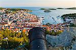 Hvar Fortress cannon and Hvar Town at sunset taken from the Spanish Fort (Fortica), Hvar Island, Dalmatian Coast, Adriatic, Croatia, Europe