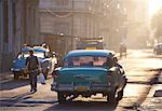 Vintage American car taxi on Avenue Colon during morning rush hour soon after sunrise, Havana Centro, Cuba, West Indies, Central America