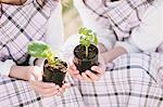 Young girls holding plants