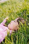 Young girl resting on grassland