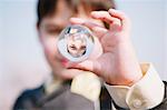 Young boy reflected on a glass sphere