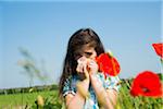 Girl Blowing Nose in Flower Field, Mannheim, Baden-Wurttemberg, Germany