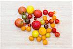 group of various fresh local organic artisanal tomatoes on wood background, jeffersonville, georgia