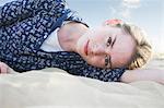 Teenage girl lying on beach