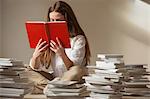 Girl sitting on floor reading book