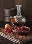 Ingredients for cranberry and Morello cherry stuffing. Cranberries, Morello cherries, apricots and brandy on carved wooden board