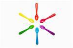 Colourful plastic spoons in a circle