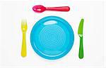 Colourful plastic plate and cutlery