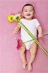 Baby girl with gerbera flowers