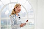 Portrait of female doctor with stethoscope and digital tablet