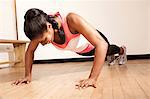 Young woman doing press ups