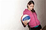 Young woman holding basketball