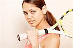 Young woman holding tennis racket