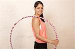 Young woman using plastic hoop