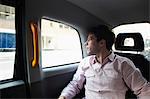Casual businessman in black cab, London, England, UK