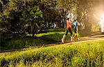 Two people jogging on forest path