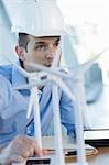 Engineer with model wind turbines