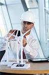 Engineer photographing model wind turbines