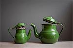 Two teapots with money inside