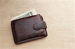 Brown leather wallet with dollar bill