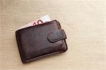 Brown leather wallet with ten Euro note