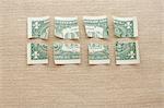 One dollar bill cut into eight pieces