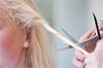 Young woman having haircut, close up