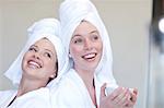 Young women wearing towels on heads with teacup