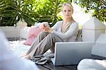 Casual business woman on patio with laptop