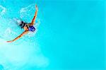 Teenage girl swimming in swimming pool