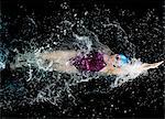 Young woman doing backstroke in swimming pool