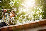 Male toddler crossing wooden footbridge