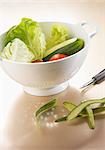 Lettuce,tomatoes and peeled cucumber in a colander