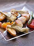 Roast scallop brochettes with vegetables and citrus fruit