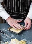 Placing the cake dough in the bottom of the buttered mould