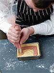 Spreading the confectioner's custard on the cake dough with a piping bag