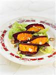 Sliced beetroots stuffed with carrot puree and walnuts