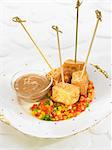 Tofu brochettes with diced vegetables and cocoa sauce
