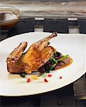 Roast pigeon with spinach,raspberries and raisins