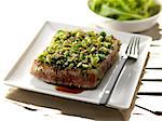 Piece of tuna coated with peas and wasabi