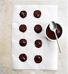 Placing small drops of the melted chocolate on wax paper