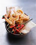 Gambas brochettes and fried bird peppers