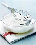 Beating a bowl of egg whites with a whisk
