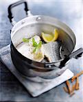 Steam-cooked bass fillets with lemon and cinnamon